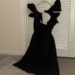 Black flowy dress, very puffy sleeves, tie able bow in the back
